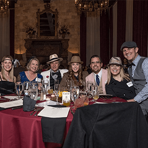 Los Angeles Murder Mystery party guests at the table