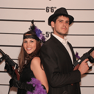 Los Angeles Murder Mystery party guests pose for mugshots